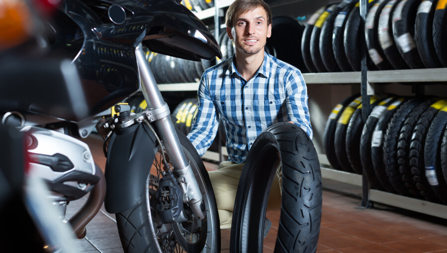 Changing the worn out motorcycle tire.